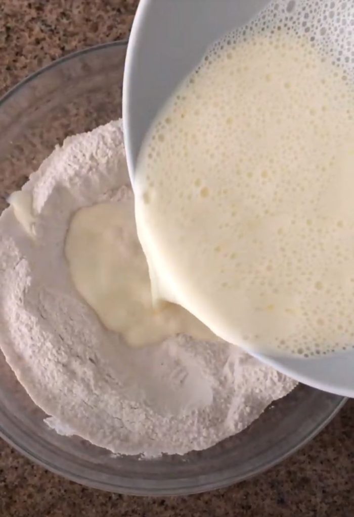 Pouring wet ingredients into dry ingredients